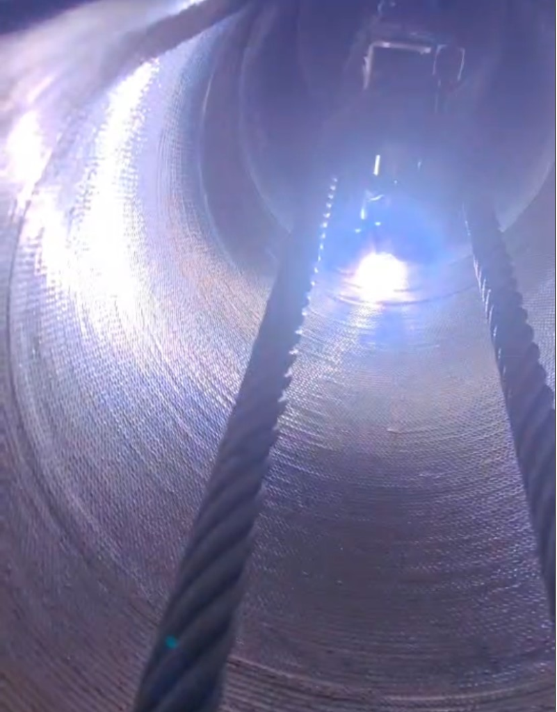 Close-up of a petrochemical pipeline section with a fresh weld overlay